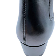 Close-up rear view of Saint Laurent Paris black leather Chelsea ankle boot showing light scuff on smooth leather heel counter, vertical stitched seam and low stacked block heel.