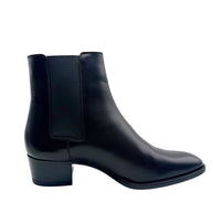 Side view of Saint Laurent Paris black leather Chelsea boot highlighting the elastic ankle gusset, streamlined silhouette and block heel.