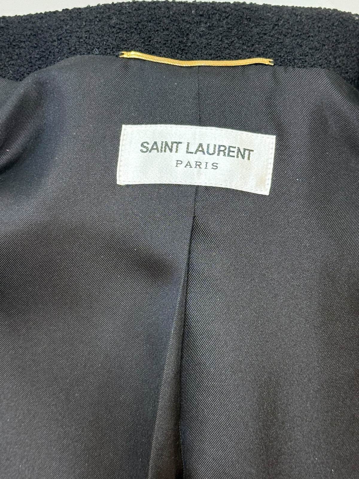 Saint Laurent Paris designer label inside green tweed jacket