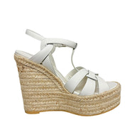 Profile view of Saint Laurent Tribute white leather espadrille platform wedge sandal with interwoven straps and natural jute wedge