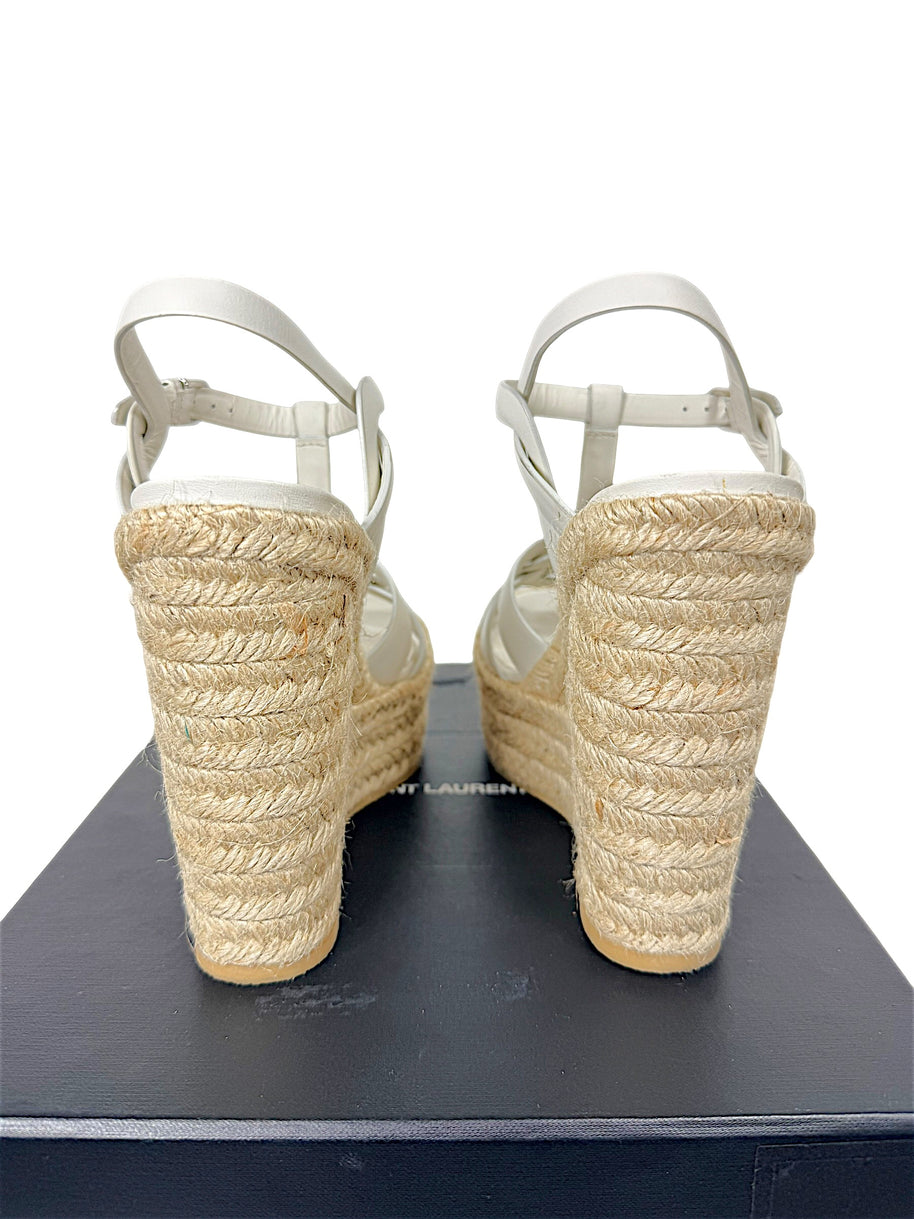 Rear view of Saint Laurent Tribute white leather sandals showing natural braided jute platform wedge and ankle straps