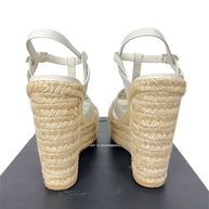 Rear view of Saint Laurent Tribute white leather sandals showing natural braided jute platform wedge and ankle straps
