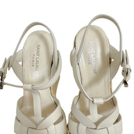 Close-up of Saint Laurent Tribute white leather espadrille sandals showing interwoven vamp, insoles and Saint Laurent Paris branding