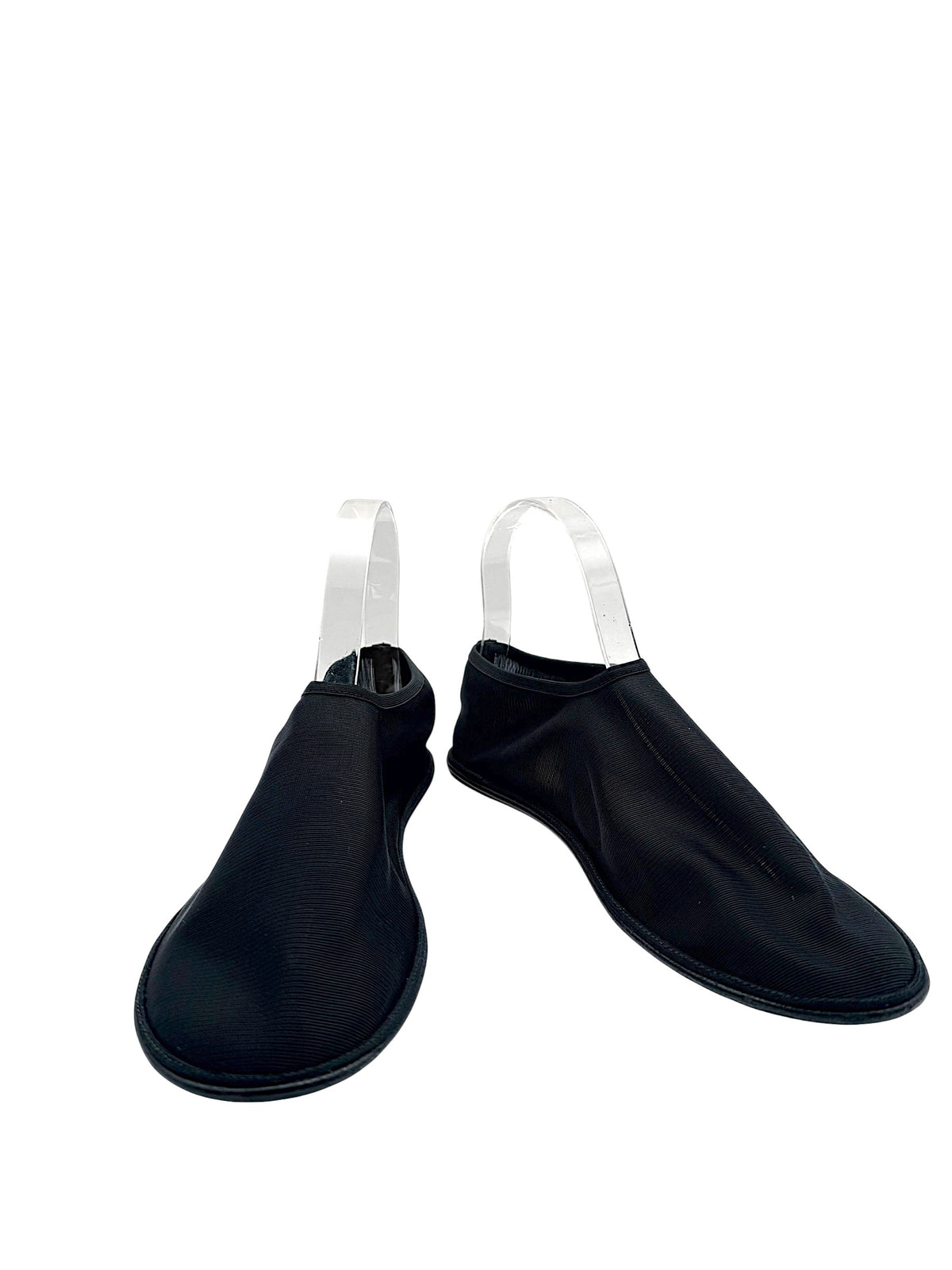 The Row black sheer mesh sock ballet flats in EU 38, front angled view showing rounded toes, ribbed nylon uppers and minimalist slip-on silhouette.