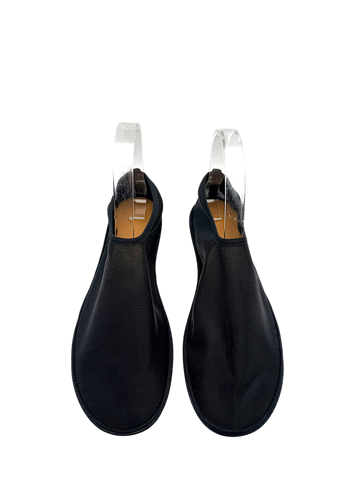 Front top view of The Row black sheer mesh sock shoes, size EU 38, showing rounded toe shape, streamlined uppers and slip-on openings.