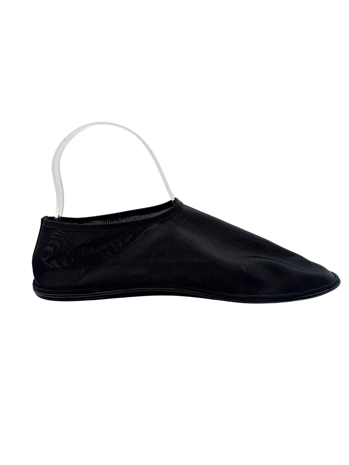 The Row black nylon mesh sock flat shown from the opposite side, with fine ribbed texture, streamlined slip-on opening and flat outsole.