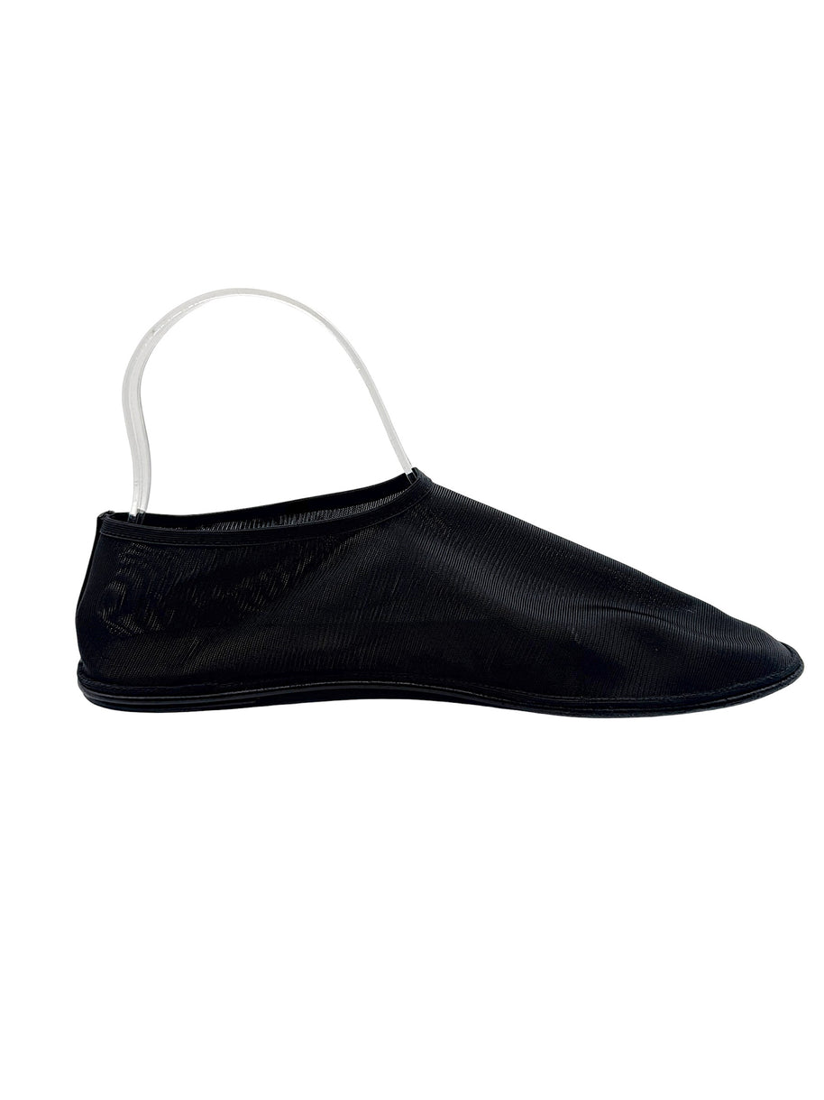 The Row black nylon mesh sock flat shown from the opposite side, with fine ribbed texture, streamlined slip-on opening and flat outsole.