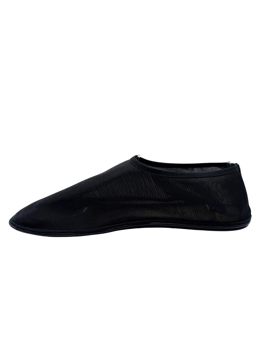Opposite side view of The Row black mesh sock shoe in EU 38, displaying semi-sheer ribbed nylon construction and minimalist flat silhouette.
