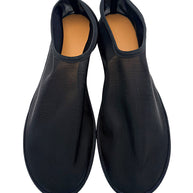 Overhead view of The Row black sheer mesh sock flats in EU 38, showing both rounded toes, ribbed uppers and tan leather footbeds.