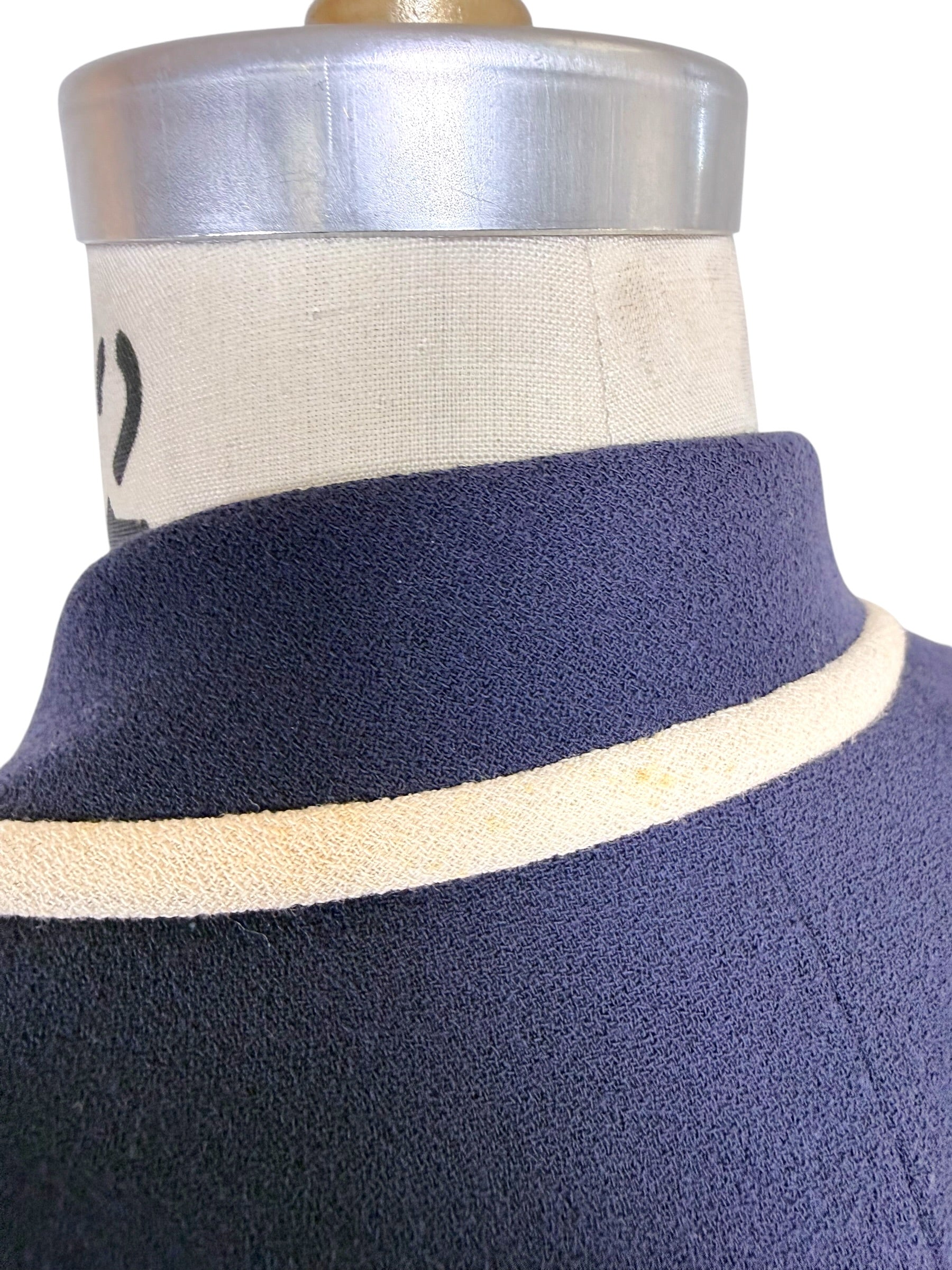 Detailed view of Valentino navy blazer collar and ivory contrast trim