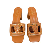 Valentino Garavani VLogo Cut-Out cognac leather sandals with gold-tone logo detail, front view