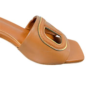 Close-up of Valentino Garavani VLogo Cut-Out with gold-tone trim on cognac leather sandal