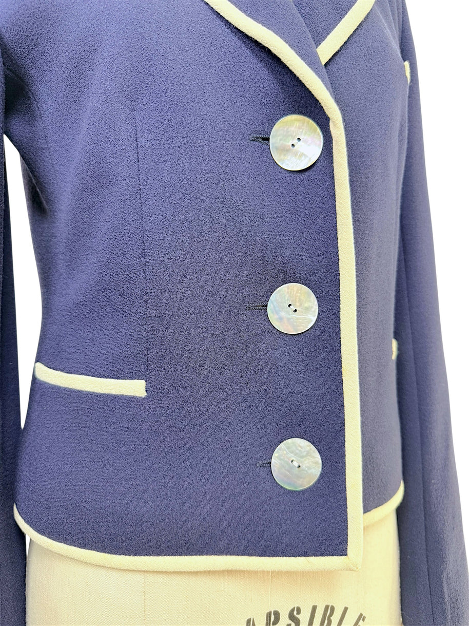 Close-up detail of Valentino blazer mother-of-pearl buttons and ivory piping