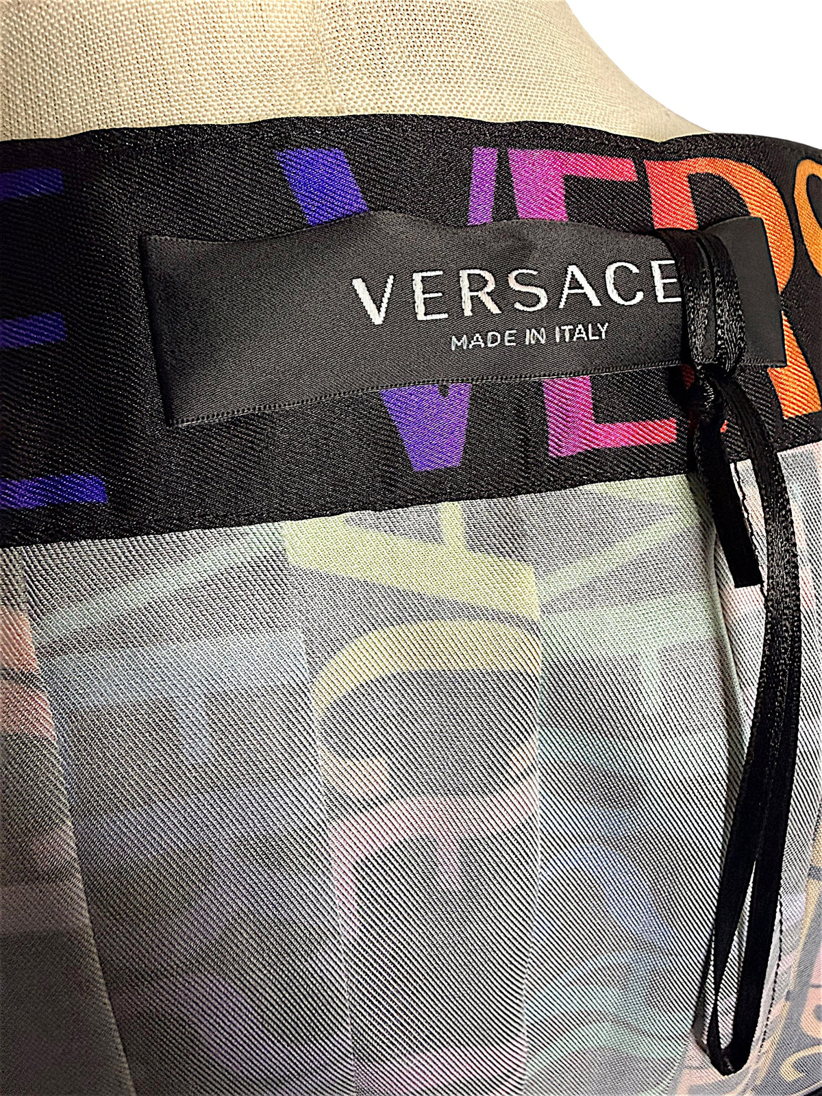 Interior Versace Made in Italy designer label on Fall Winter 2021 La Greca multicolor pleated skirt.