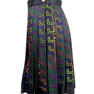 Side view of Versace FW 2021 La Greca skirt featuring a gold-tone Medusa button at the high waistband and multicolor pleated geometric fabric.