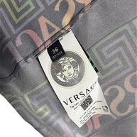 Close-up of Versace Fall Winter 2021 La Greca pleated skirt interior showing Italian size 36 label, Medusa emblem, NFC authentication tag and printed fabric.