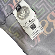 Versace La Greca pleated skirt interior tag showing Italian size 36, Medusa emblem and NFC product authentication information.