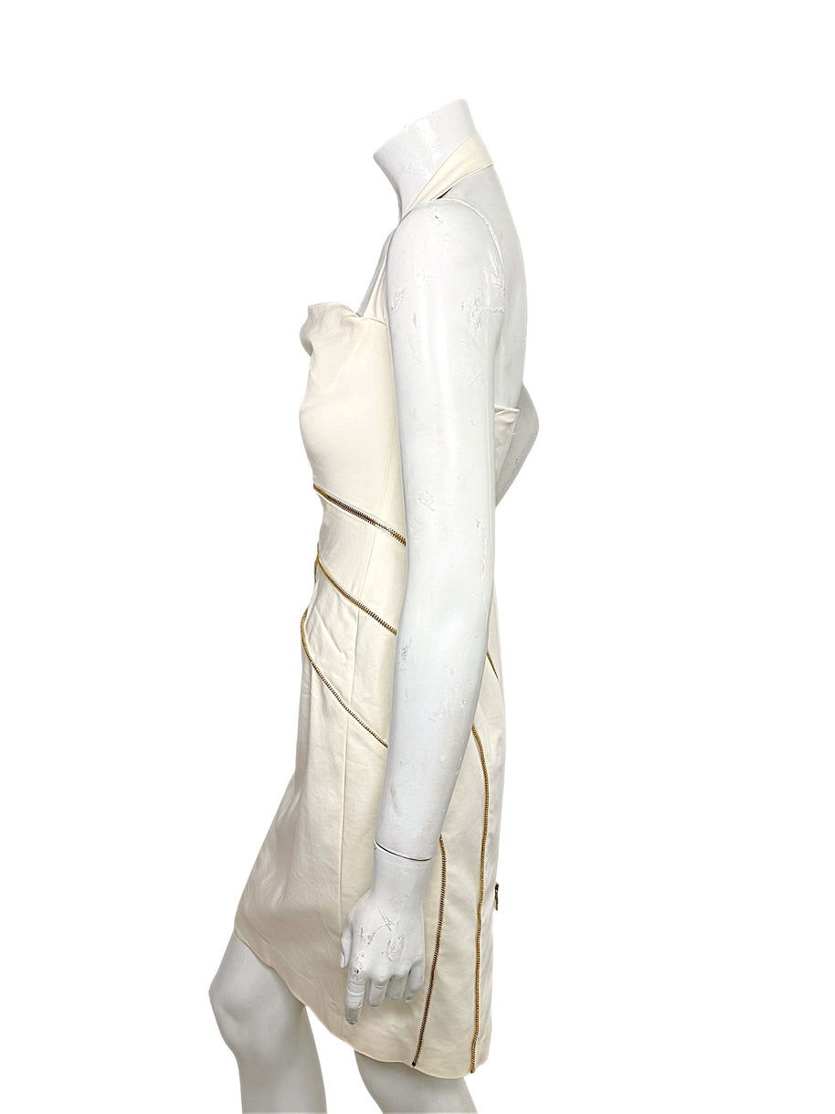 Side profile of Versace Spring 2009 Look 6 ivory fitted dress with halter neckline and gold zippers