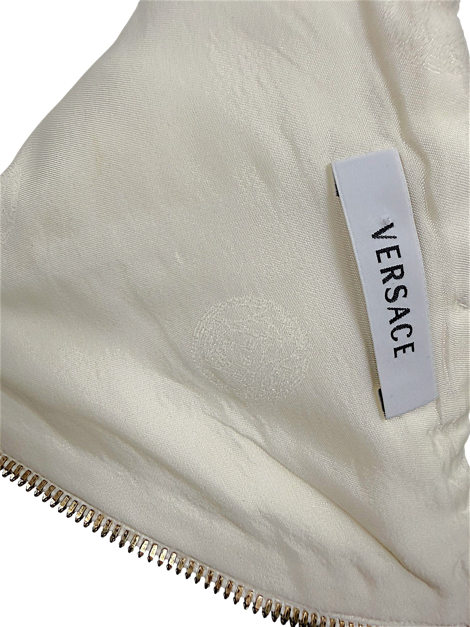 Interior Versace logo label and tonal Medusa lining detail on Spring 2009 ivory runway documented dress