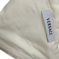 Interior Versace logo label and tonal Medusa lining detail on Spring 2009 ivory runway documented dress