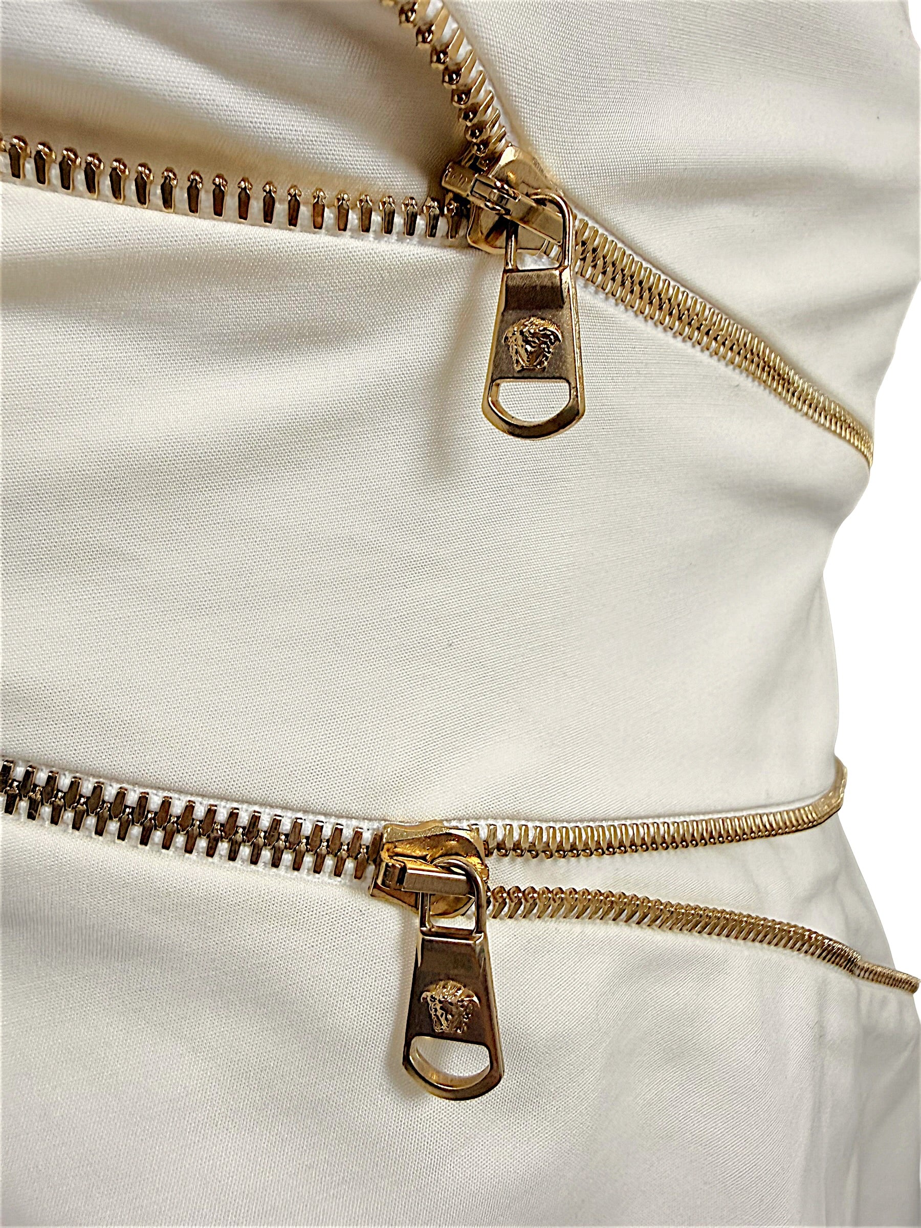 Close-up of gold-tone Medusa zipper pulls on Versace Spring 2009 ivory runway dress