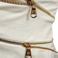 Close-up of gold-tone Medusa zipper pulls on Versace Spring 2009 ivory runway dress