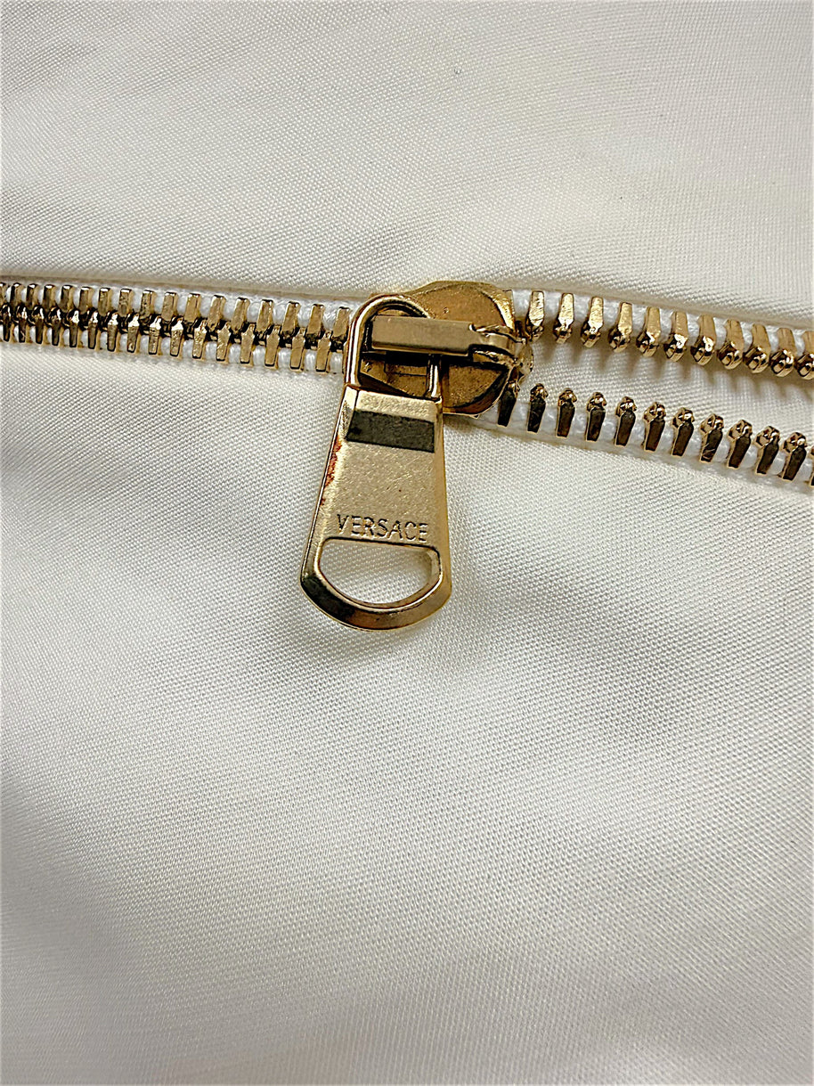 Close-up of Versace engraved gold-tone zipper pull on Spring 2009 ivory dress