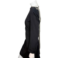 Side view of vintage 1980s Bob Mackie black cocktail dress showing long sleeves and silver beaded open-back detailing