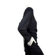Side profile of vintage Bob Mackie black long sleeve cocktail dress showing fitted knee-length silhouette