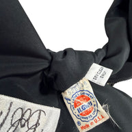 Close-up of vintage ILGWU union and Made in USA labels inside Bob Mackie black beaded dress