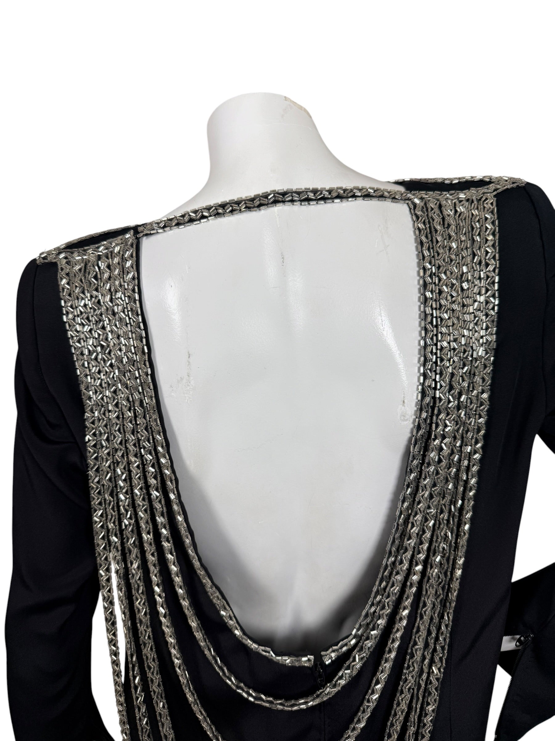 Close-up of dramatic open back framed with dense silver bugle bead embroidery on vintage Bob Mackie dress