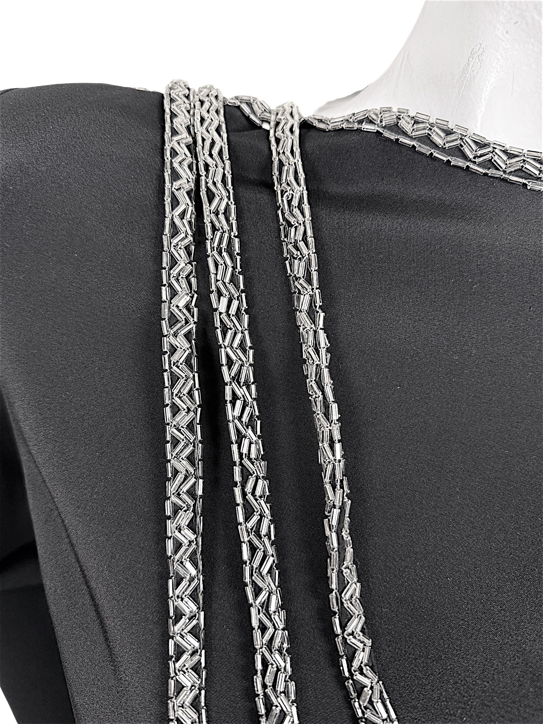 Close-up of silver bugle bead embroidery and cascading beaded strands on vintage Bob Mackie dress