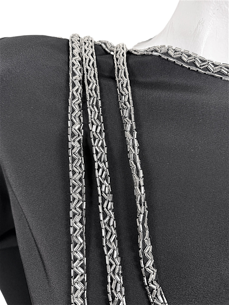 Close-up of silver bugle bead embroidery and cascading beaded strands on vintage Bob Mackie dress