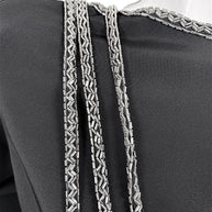 Close-up of silver bugle bead embroidery and cascading beaded strands on vintage Bob Mackie dress