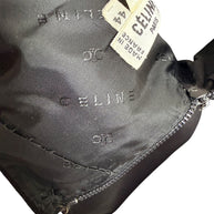 Interior of vintage Céline black wool skirt showing woven Céline logo jacquard lining, original designer label, and rear zipper construction.