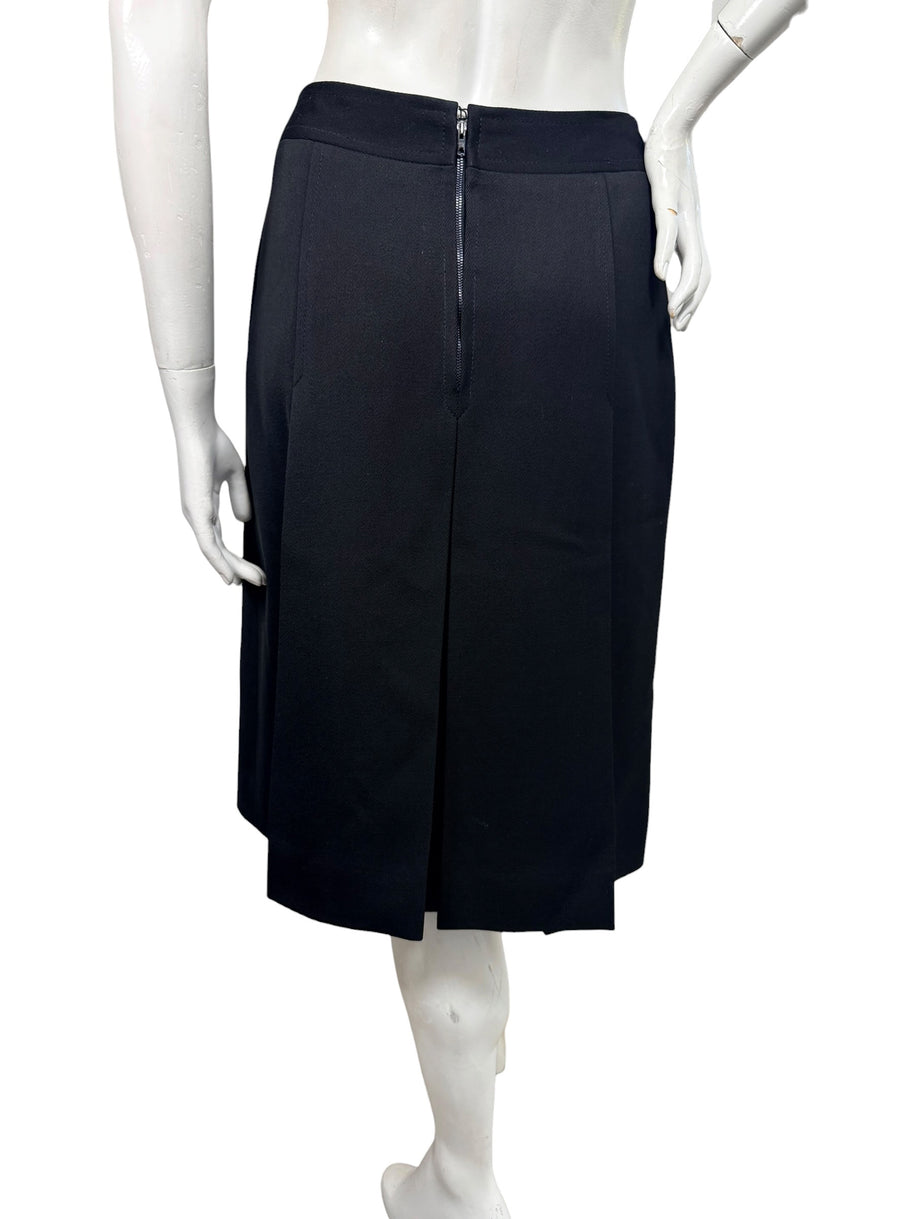 Rear view of vintage Céline black wool pleated midi skirt featuring a center-back zipper, tailored waistband, and structured pleated panels.