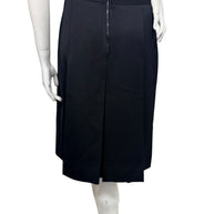Rear view of vintage Céline black wool pleated midi skirt featuring a center-back zipper, tailored waistband, and structured pleated panels.