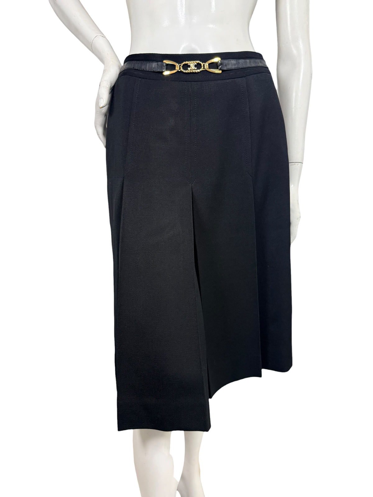 Vintage Céline black wool pleated midi skirt shown from the front with integrated leather waistband and gold-tone Double-C logo hardware.