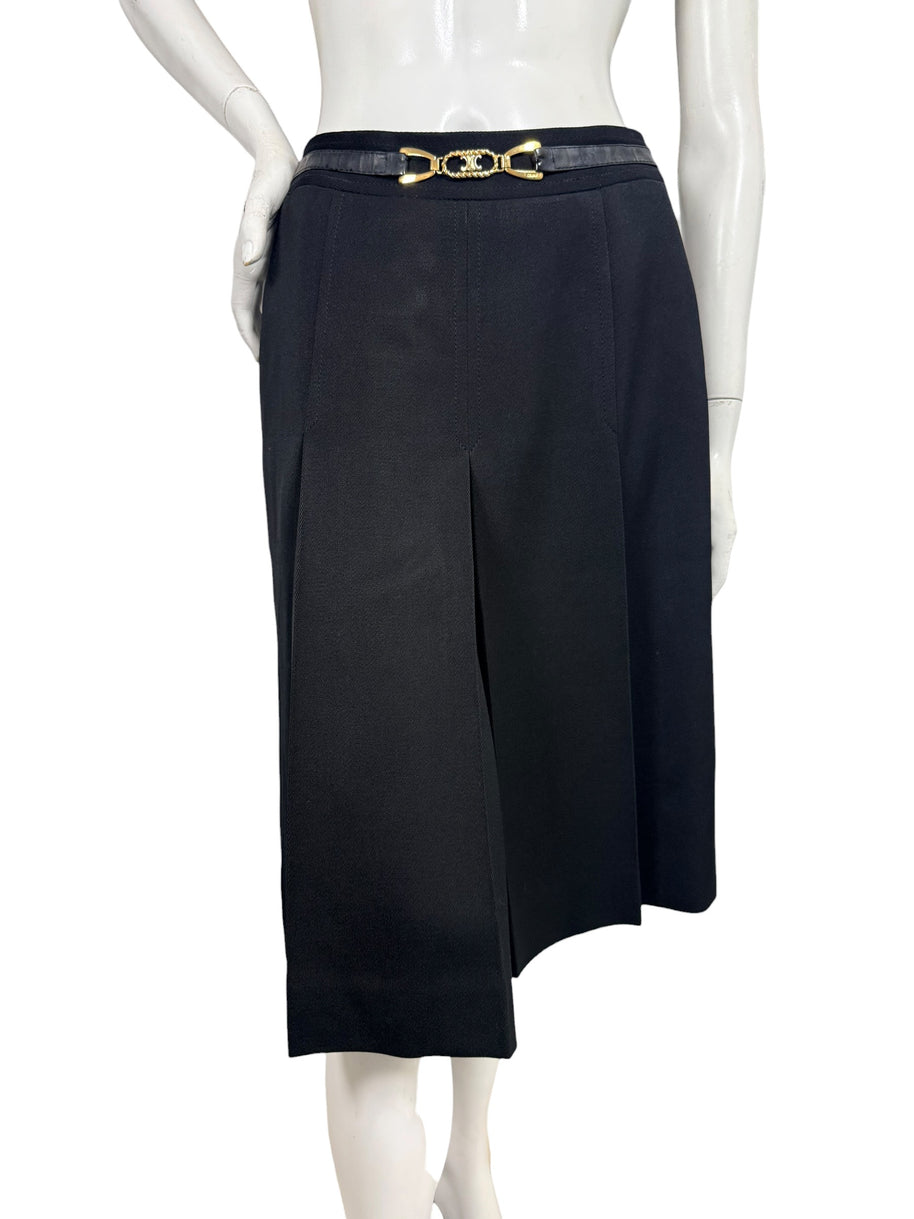 Vintage Céline black wool pleated midi skirt shown from the front with integrated leather waistband and gold-tone Double-C logo hardware.