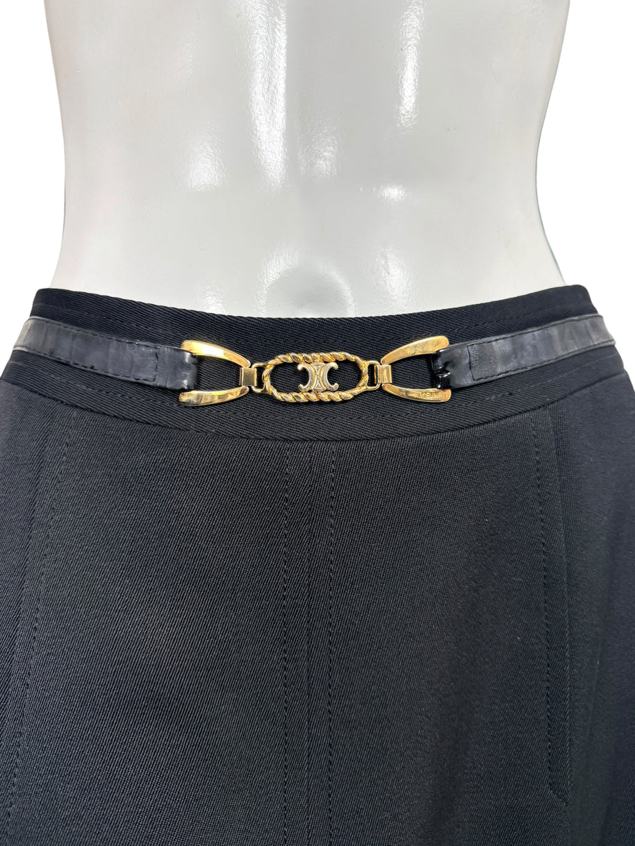 Close-up of vintage Céline skirt featuring a black leather belt, gold-tone interlocking Double-C emblem, and tailored black wool waistband.