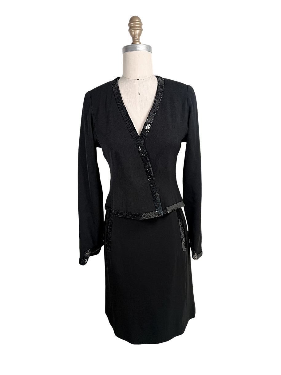 Vintage Chanel black skirt suit set featuring tonal sequin trim with wrap-style jacket and coordinating skirt front view