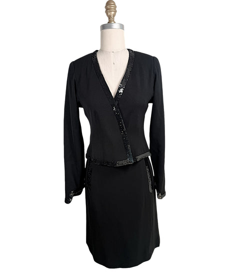 Vintage Chanel black skirt suit set featuring tonal sequin trim with wrap-style jacket and coordinating skirt front view