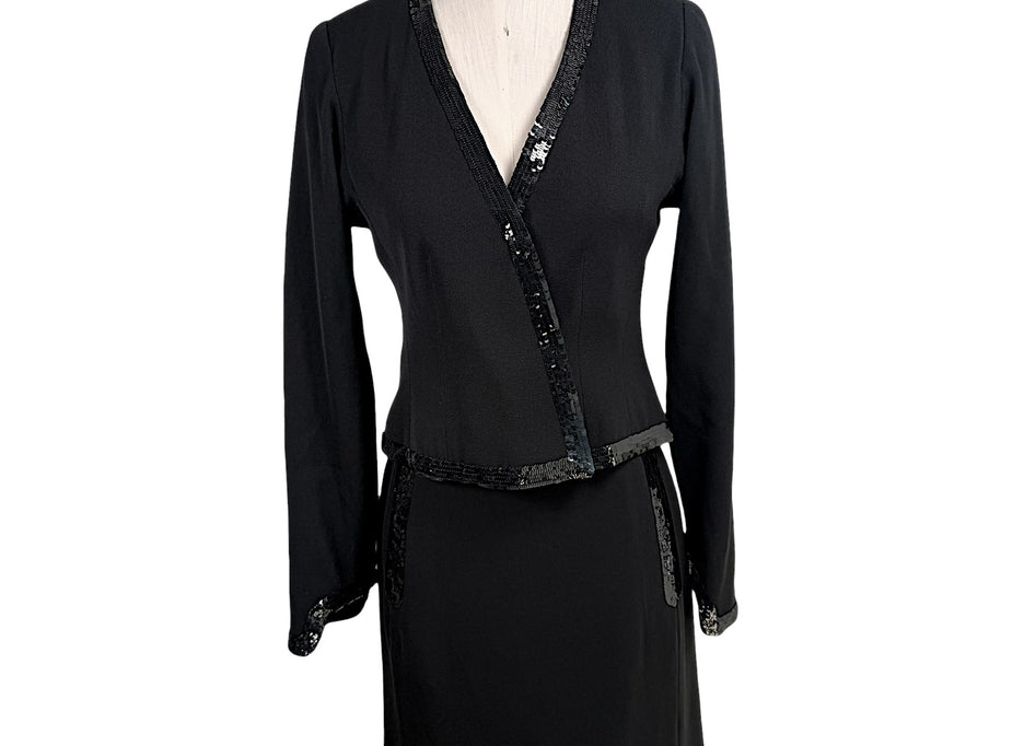 Vintage Chanel black skirt suit set featuring tonal sequin trim with wrap-style jacket and coordinating skirt front view