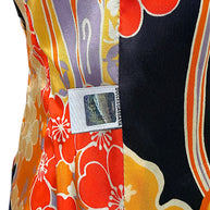Close-up of Dolce & Gabbana branded security label sewn into the multicolored floral interior lining of a vintage D&G blazer.