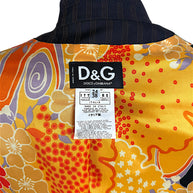 Close-up of original D&G Dolce & Gabbana Made in Italy designer label, Italian size 38 and fabric composition tag against colorful floral lining.