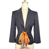 Vintage D&G by Dolce & Gabbana navy pinstripe tailored blazer with structured shoulders, fitted waist and colorful floral silk scarf tie, front view.