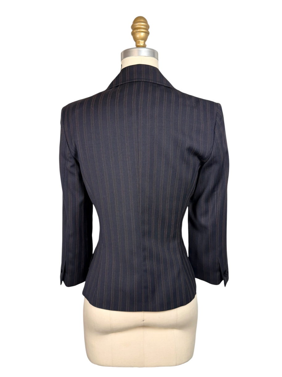 Back view of vintage D&G by Dolce & Gabbana navy pinstripe blazer showing fitted waist, shaped seams and structured shoulders.