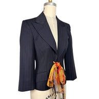 Three-quarter view of vintage D&G Dolce & Gabbana navy pinstripe blazer featuring notched lapels, sculpted waist and vibrant floral silk tie.