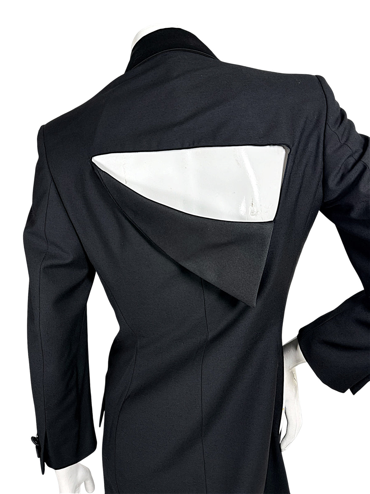 Close-up of the distinctive angular cutout back on a vintage Gianni Versace Couture black blazer, showing the folded panel and precise tailored seams.
