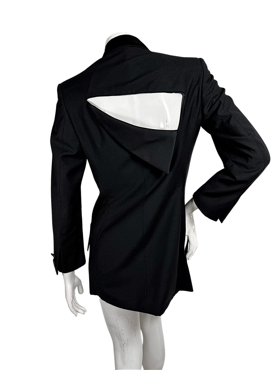 Full back view of vintage Gianni Versace Couture black blazer featuring a dramatic geometric upper-back cutout and sculptural overlapping fabric panel.